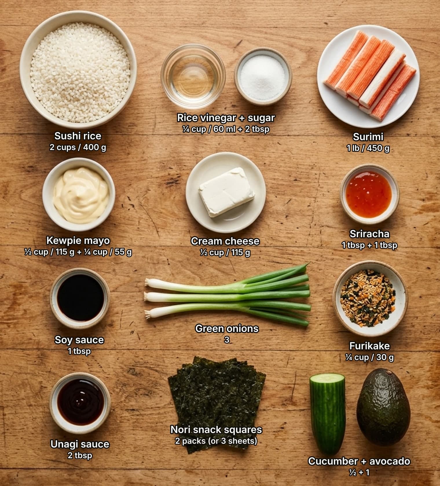 Sushi bake ingredients laid out overhead on a wooden counter and labelled with quantities: a bowl of raw short-grain rice, a glass dish of rice vinegar beside a bowl of sugar, and a plate of surimi sticks across the top; bowls of Kewpie mayonnaise, a block of cream cheese and a dish of sriracha in the second row; a dish of soy sauce, three green onions and a bowl of furikake in the third row; a dish of unagi sauce, a stack of nori snack squares, and half a cucumber beside an avocado below.